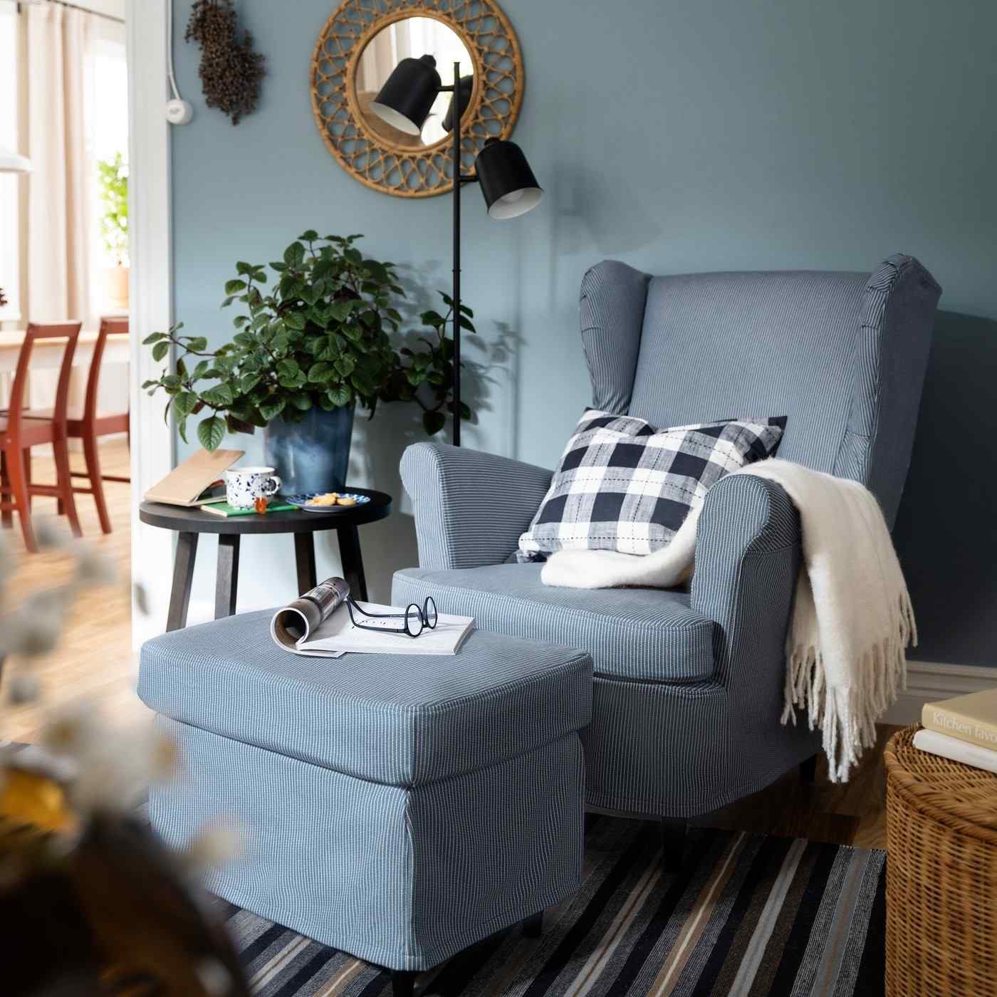 A separate source reading corner groups a wing chair, matching footstool, floor lamp, and side table.