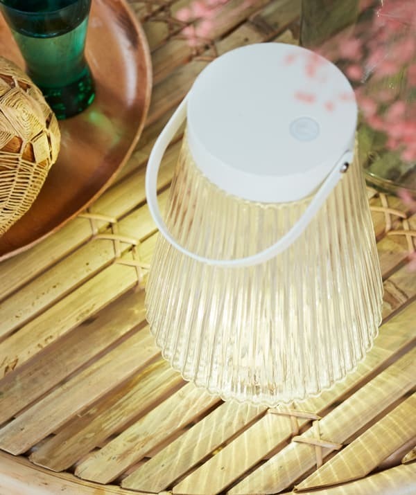 The IKEA solar-lighting reference shows a separate portable light beside an outdoor tray.