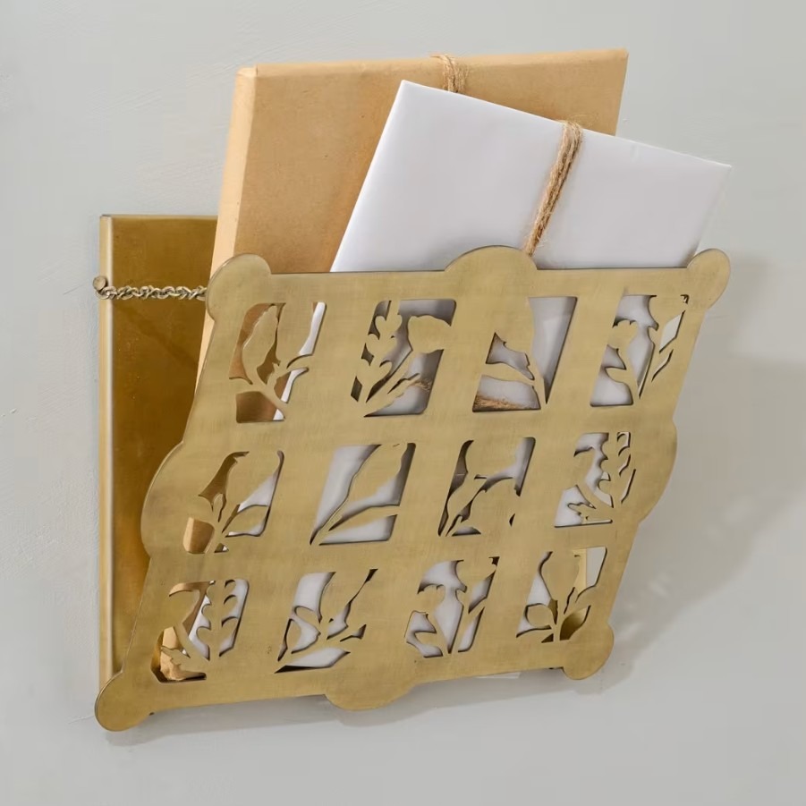 A decorative brass wall pocket appears in the source shopping selection as an example of giving loose papers a defined visible destination.