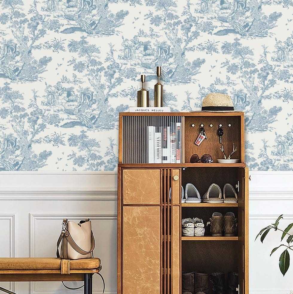 A separate source shopping presentation places blue-and-white toile behind a storage cabinet, illustrating its effect beyond the cover setting.