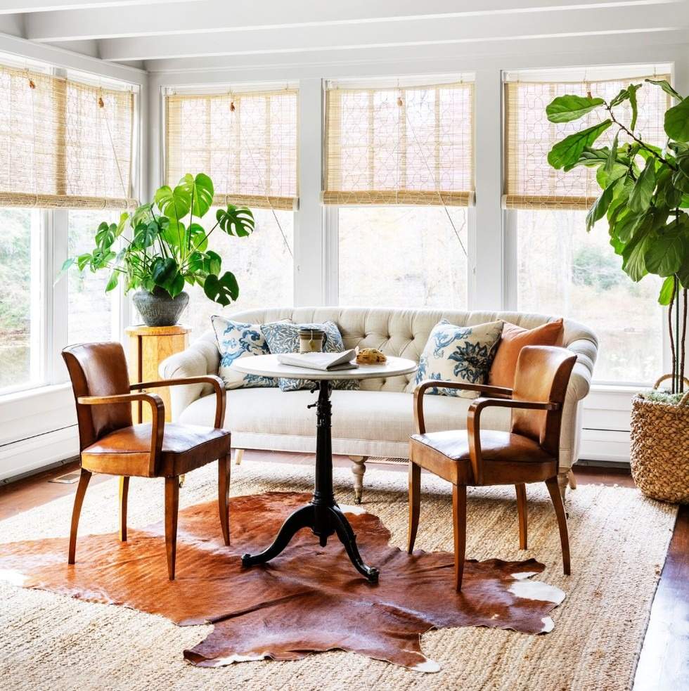 The reference illustrates a smaller hide-shaped rug layered over a larger natural-textured base.
