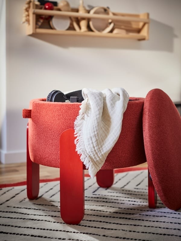 The source storage pouffe is pictured with its top removed, making its internal compartment and opening method visible.