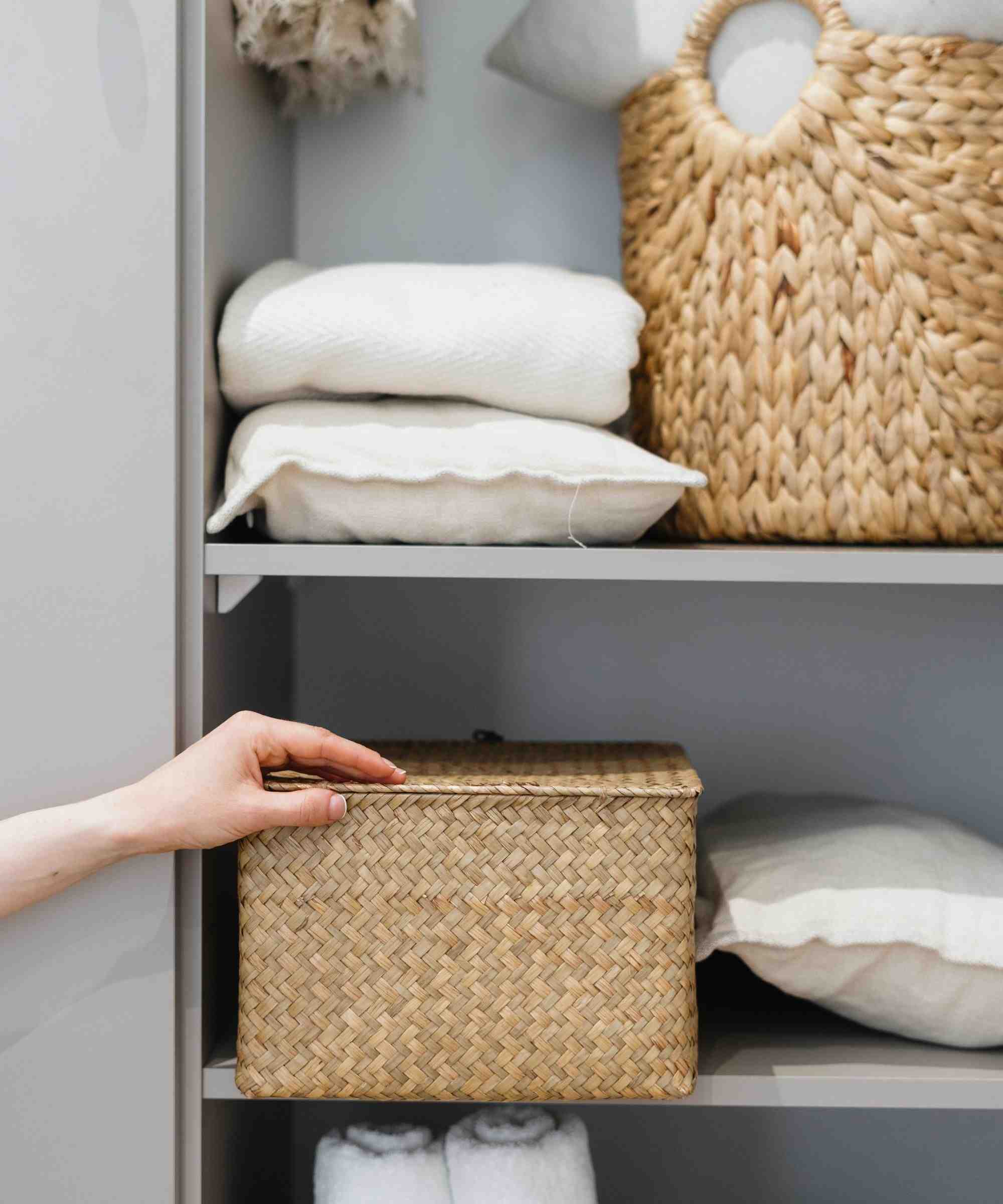 A separate source storage example groups folded textiles on shelves with woven baskets, illustrating defined locations for different contents.