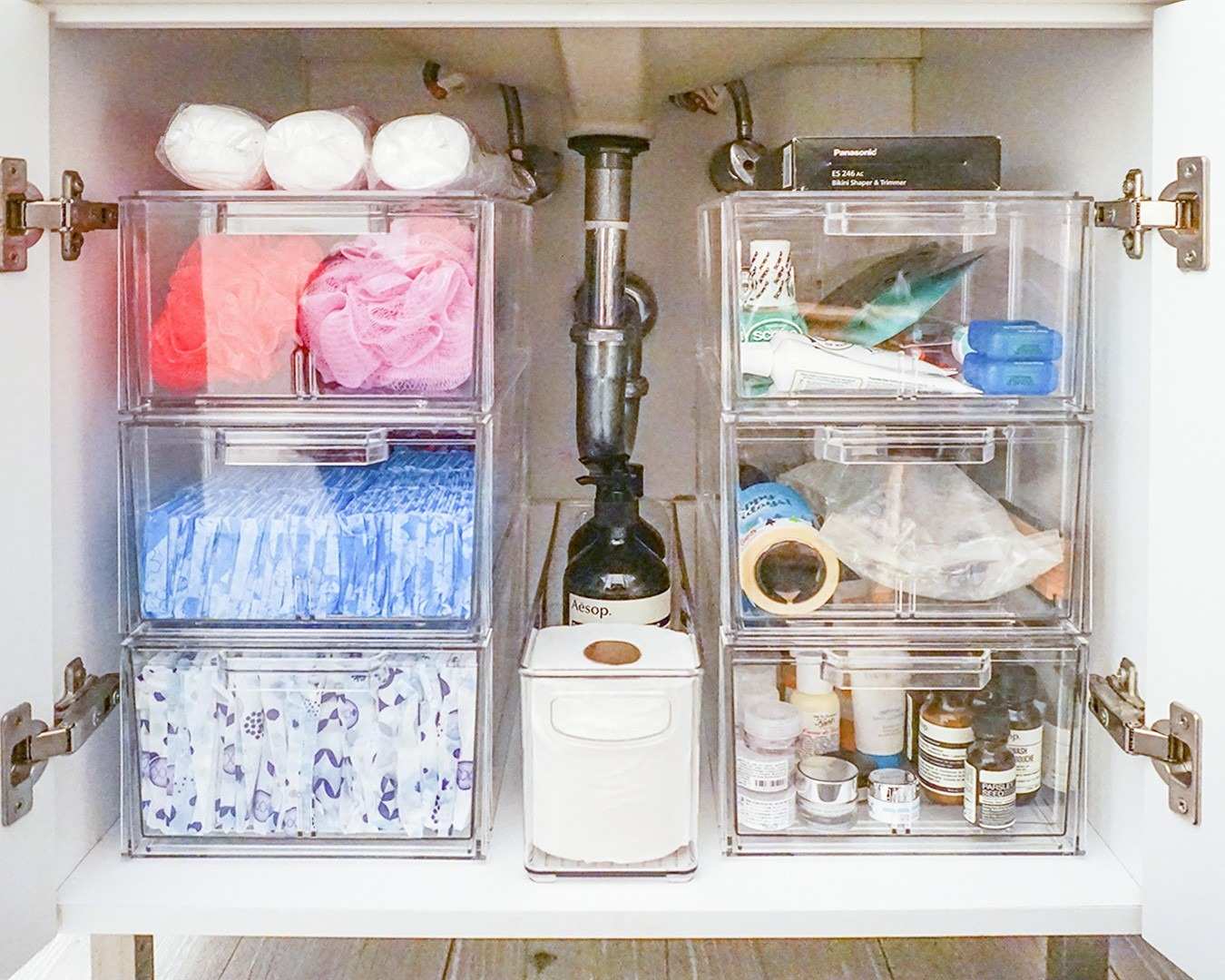 A separate source sink cabinet arranges clear containers around the plumbing while leaving the pipework visible.