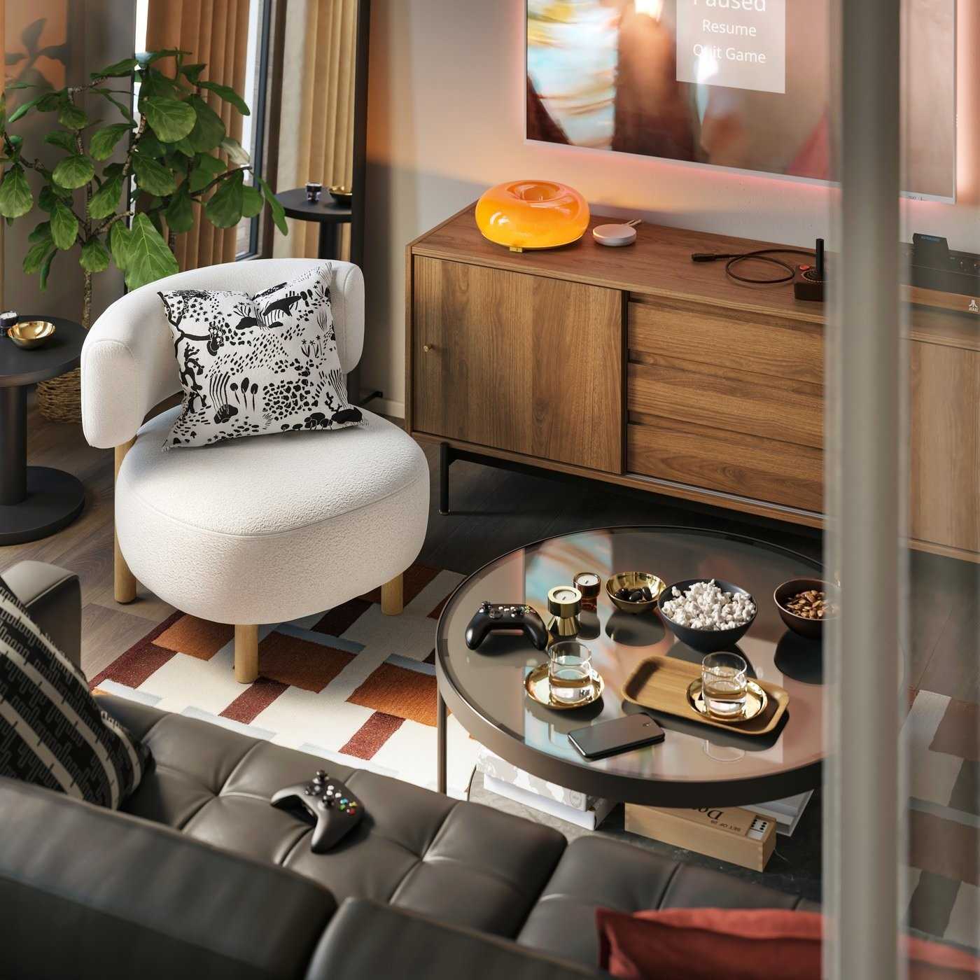 A separate source seating view places an armchair and coffee table beside the TV bench, illustrating the social side of the gaming room.