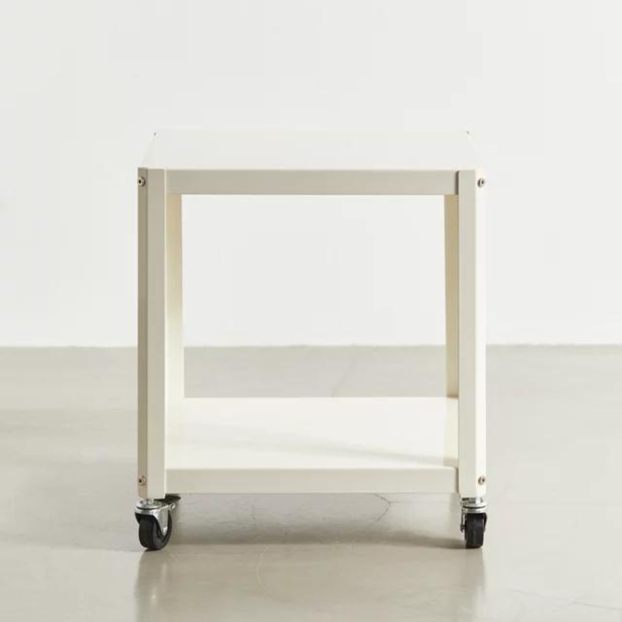 The white two-tier rolling table appears in the source shopping roundup as a possible bedside or movable supporting surface.