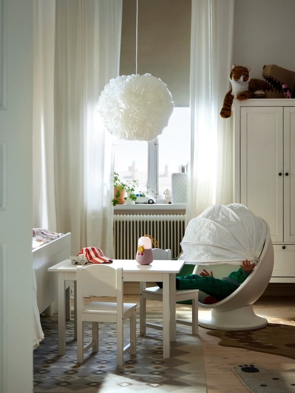 A separate view in the source shows a child-sized table and chairs beside the window within the coordinated family room.
