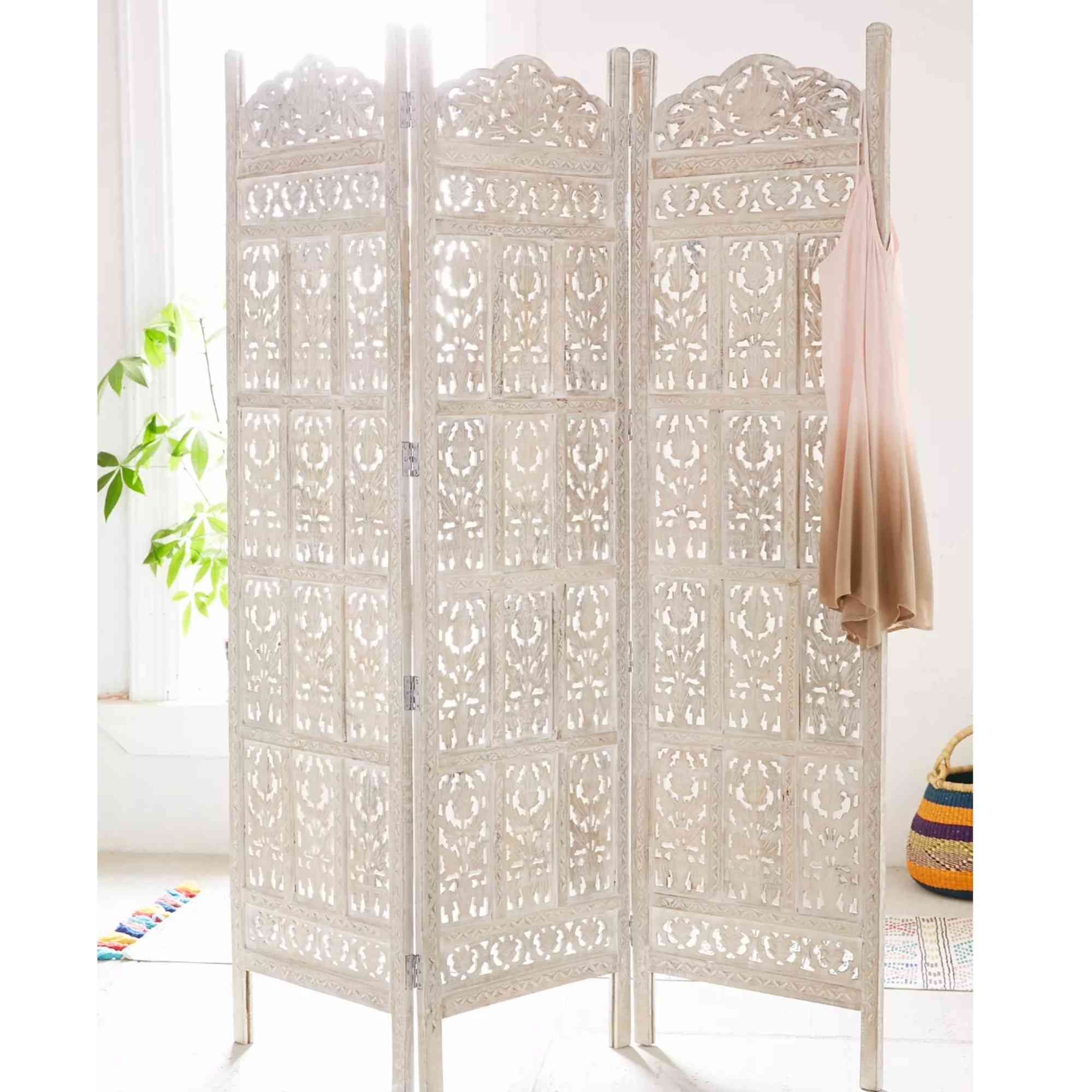 The source shopping edit includes a carved white folding screen, providing an alternative to the darker floral screen on the cover.