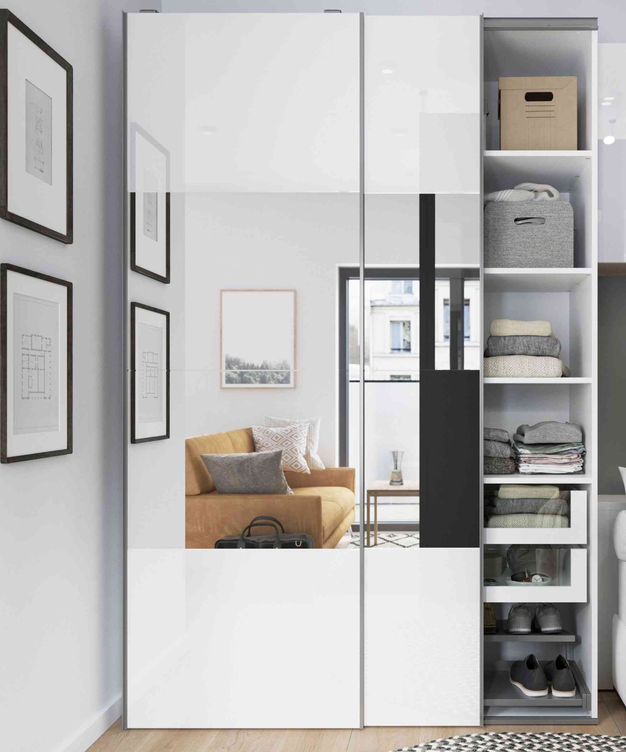 A separate source wardrobe uses a mirrored door that reflects the chair and wall art, with open shelves alongside.