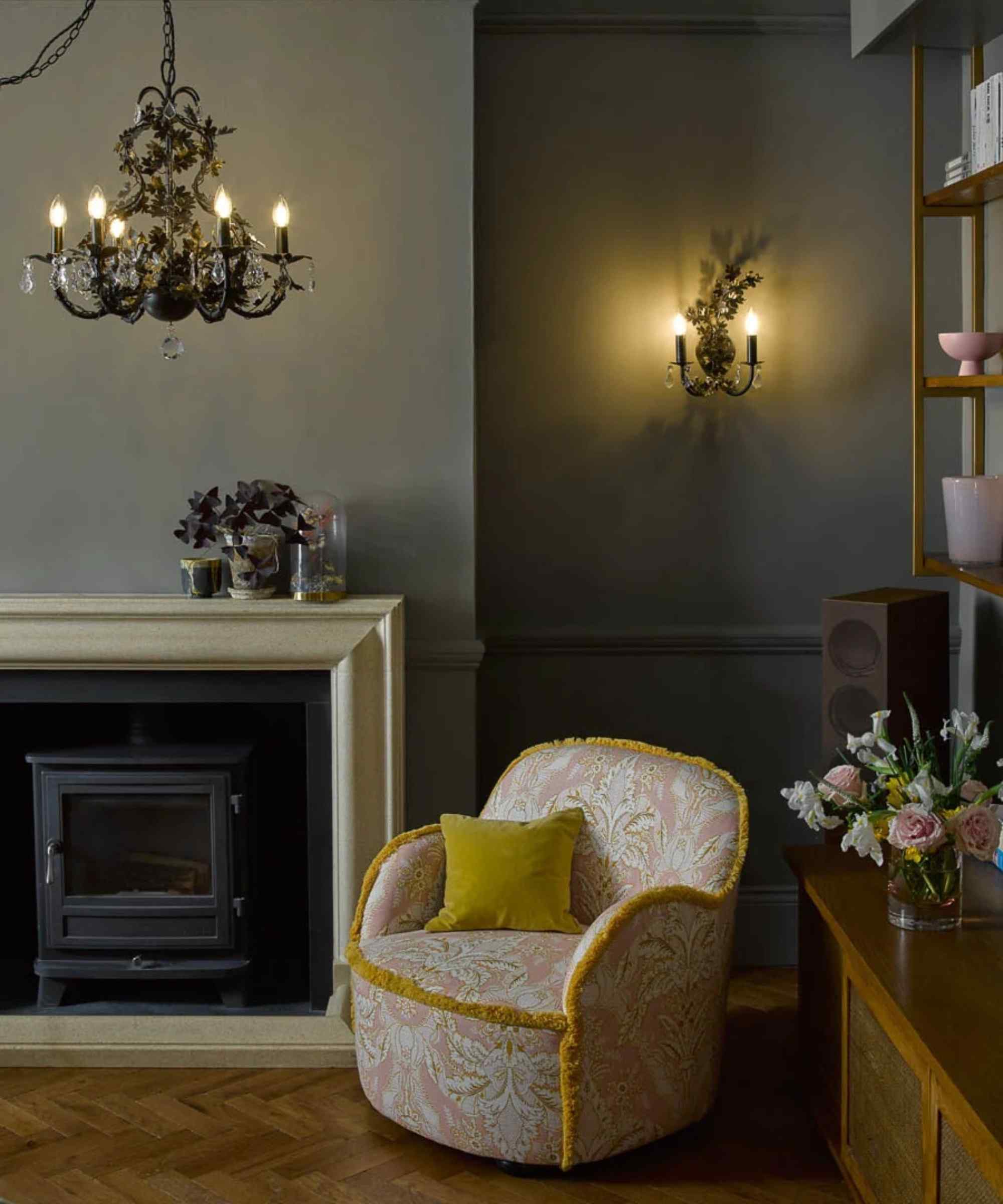 A reference room combines a chandelier with a local wall light beside an armchair, demonstrating light at different positions.