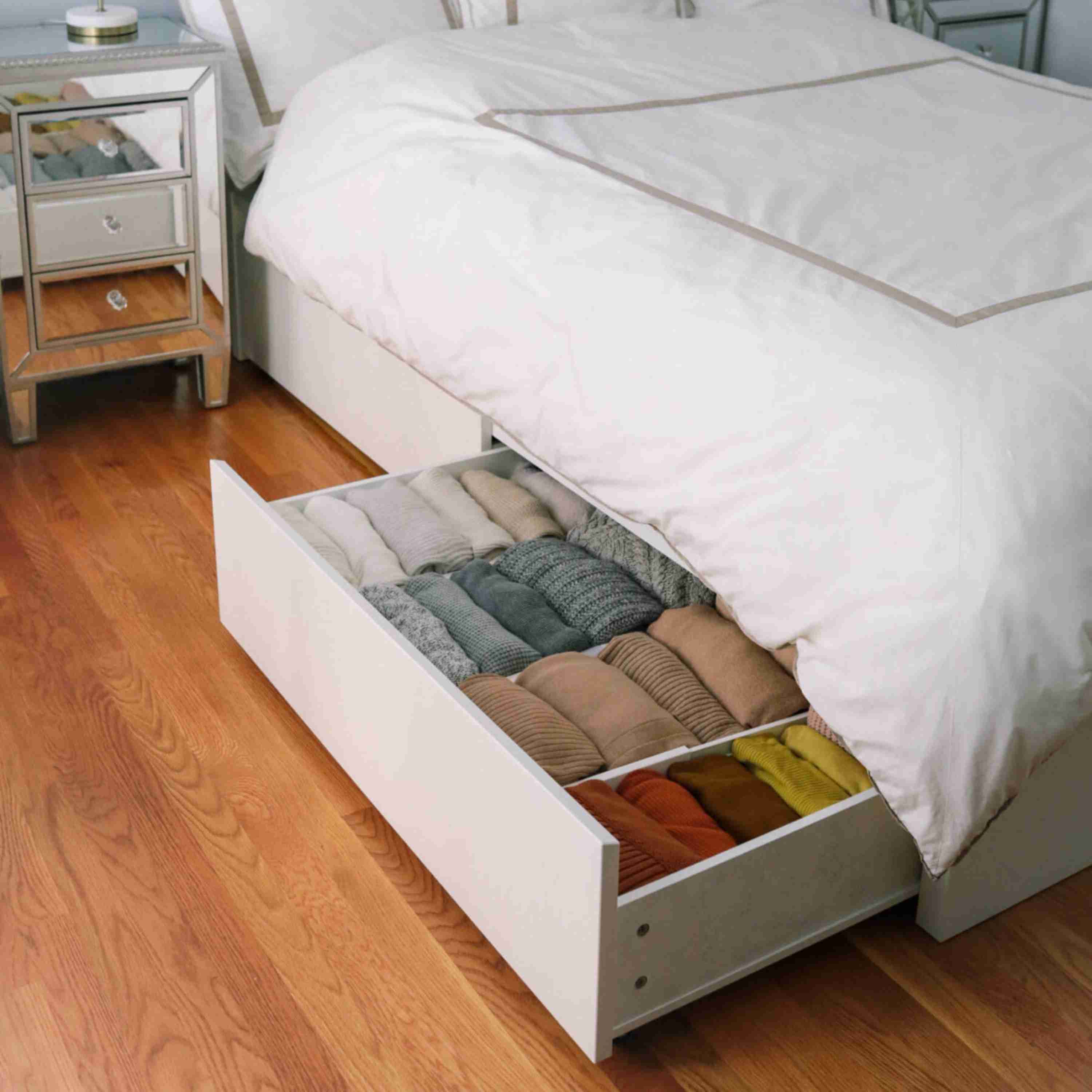 A separate source detail shows an open under-bed drawer with clothing arranged inside.