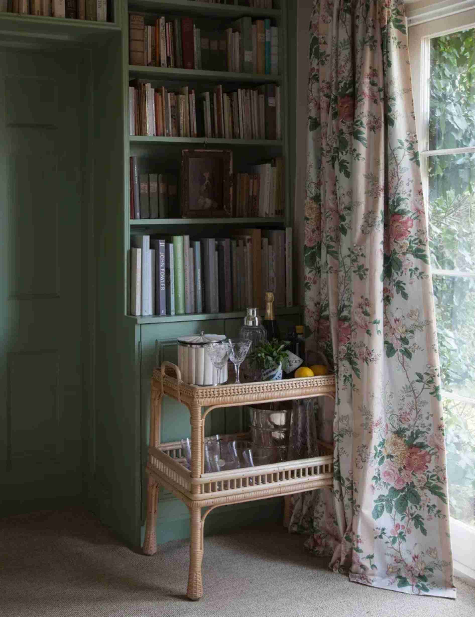 A separate source room uses a rattan cart as a compact supporting storage piece beside taller shelving.