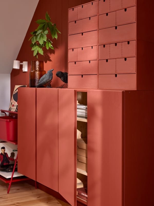 The source storage detail uses red-painted small drawer units above a cabinet in a related red wall setting.