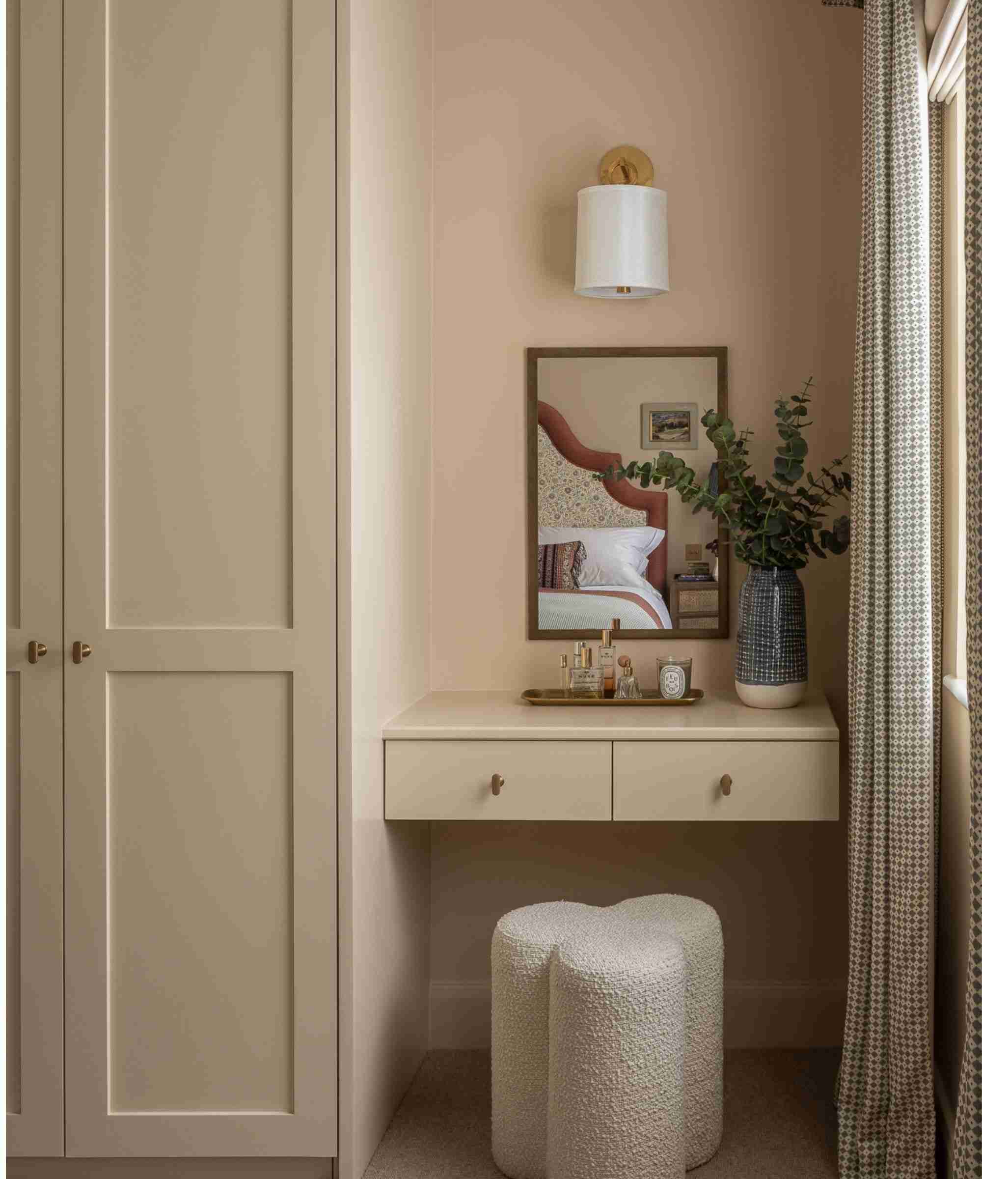 A separate source example combines fitted cabinetry with a floating dressing surface and a stool that occupies the space below.