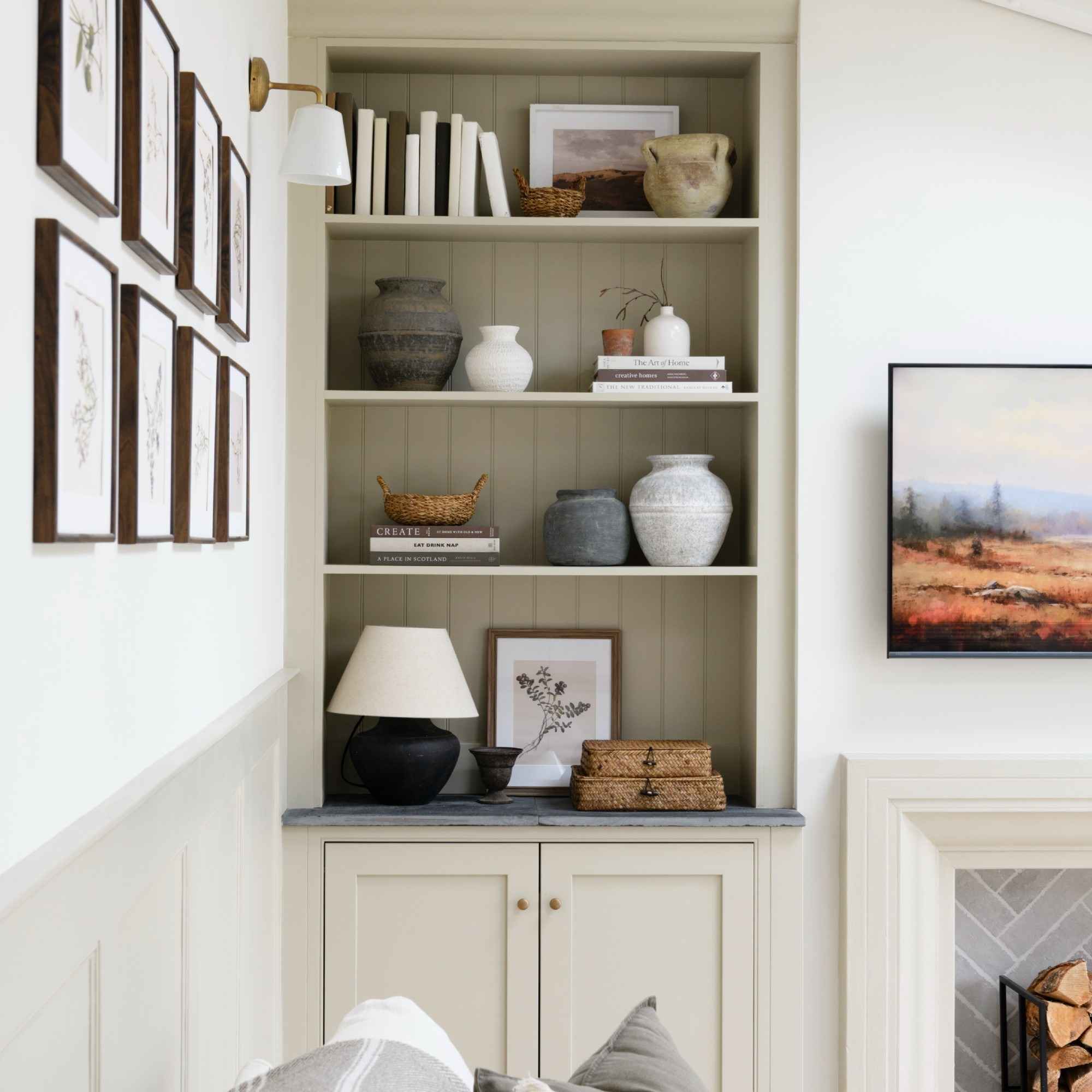 The reference includes both a small lamp within an alcove and a wall light above the cabinetry.