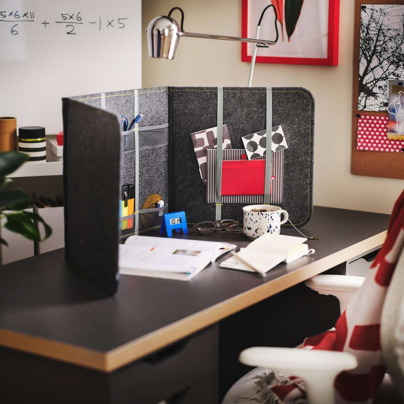 The source desk divider incorporates pockets for small supplies while screening part of the desktop from view.