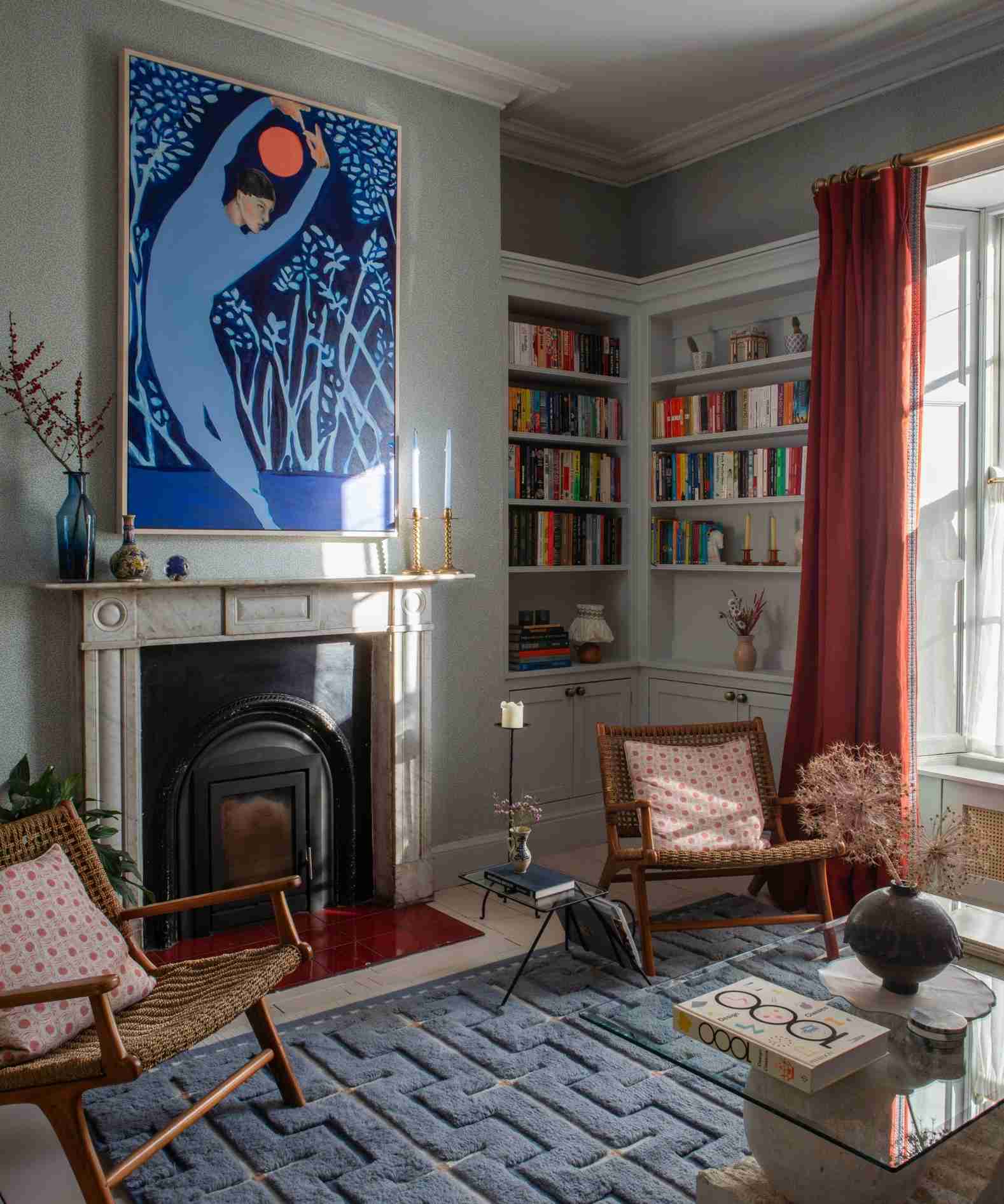 A separate source living room illustrates the relationship between seating, artwork, and surrounding surfaces that a layered lighting scheme needs to address.