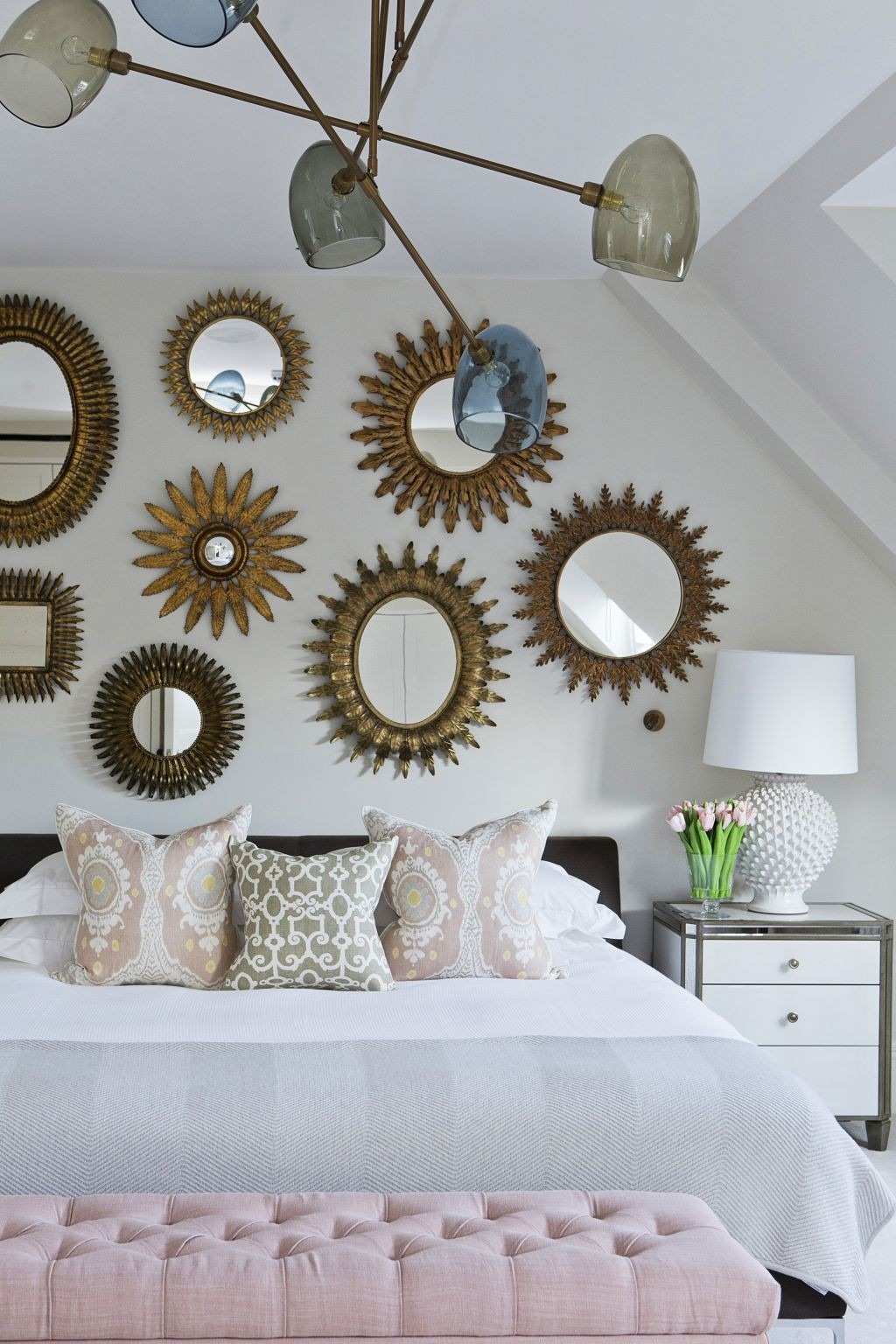 The source mirror-wall example repeats framed mirrors above a bed, illustrating reflection as a visual decorating layer.