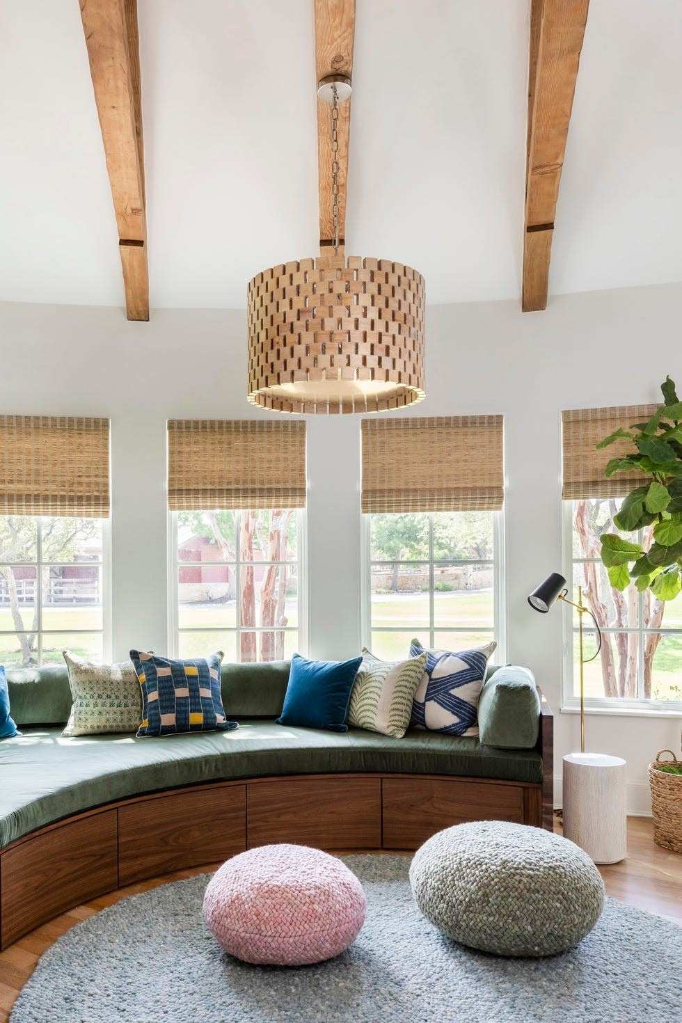 A separate source interior uses selected colored cushions and smaller upholstered seats within a quieter architectural setting.