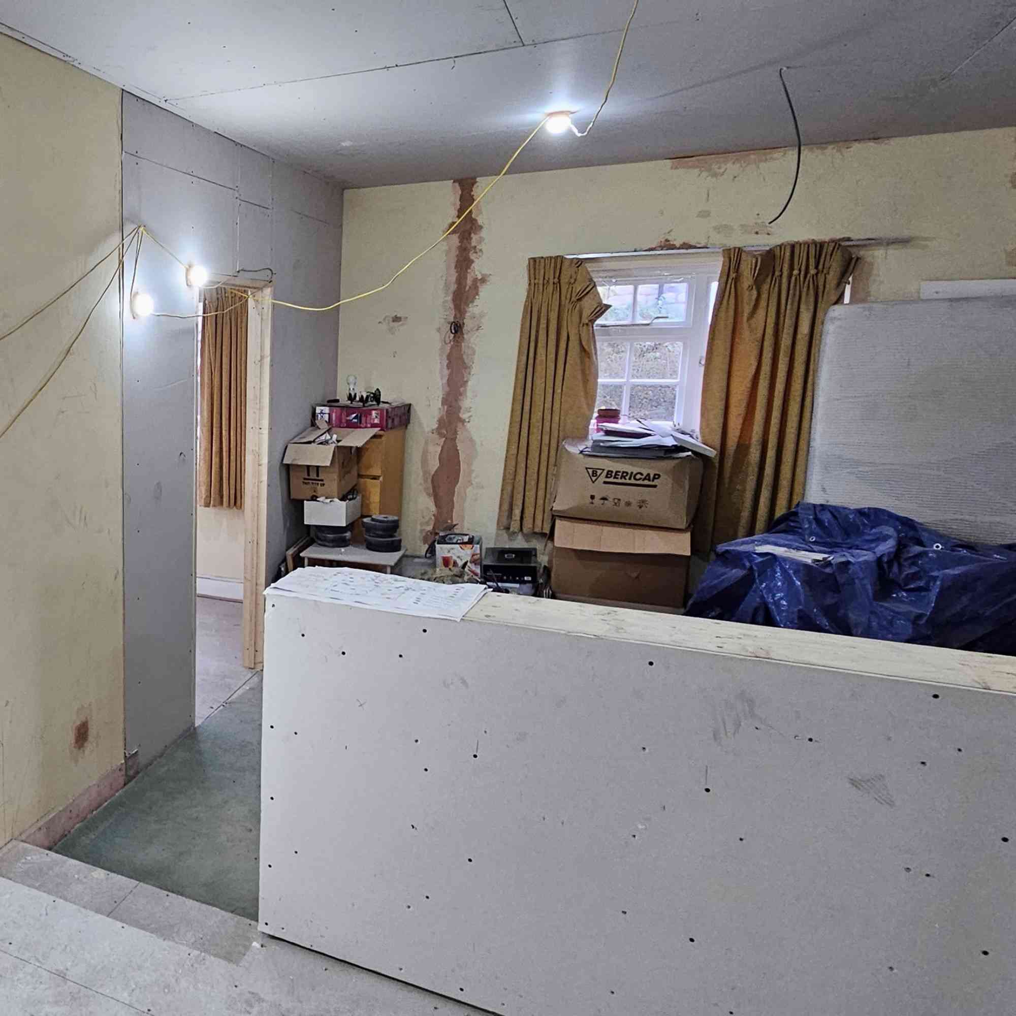 The source project before construction shows the existing low wall that supported the later open divider.