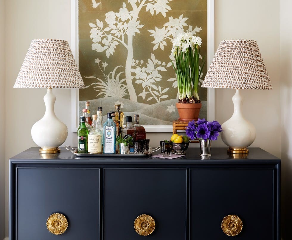 The repurposed source console is shown as a dark-painted sideboard bar with distinctive circular hardware.