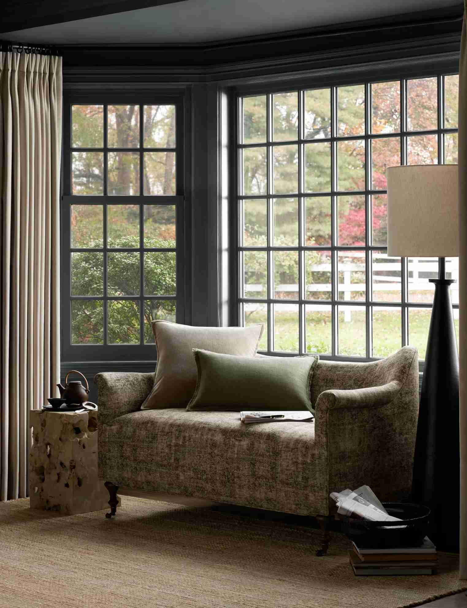 A separate source seating example shows a patterned settee positioned within a window nook.
