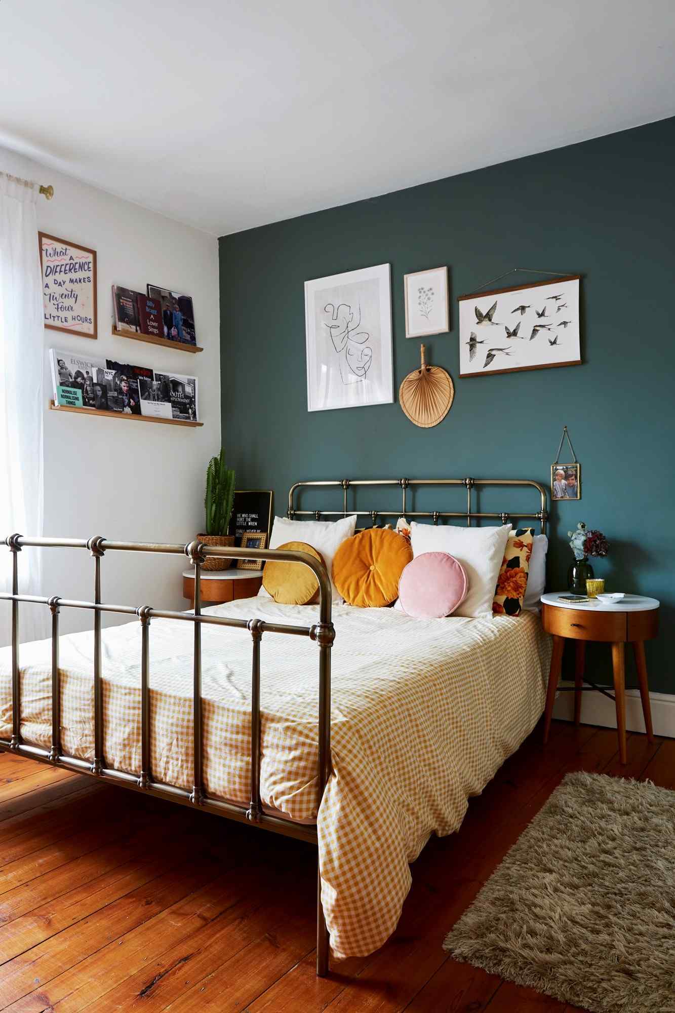 A separate source bedroom places a metal-framed bed against a deep green wall with yellow bedding and small supporting furniture.