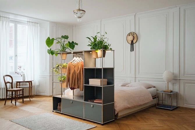 The reference shows storage with plants forming a boundary beside a bed while retaining open views through parts of the unit.