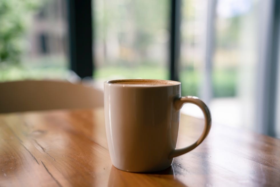A source image of a mug on timber illustrates the everyday heat and moisture exposure discussed here.