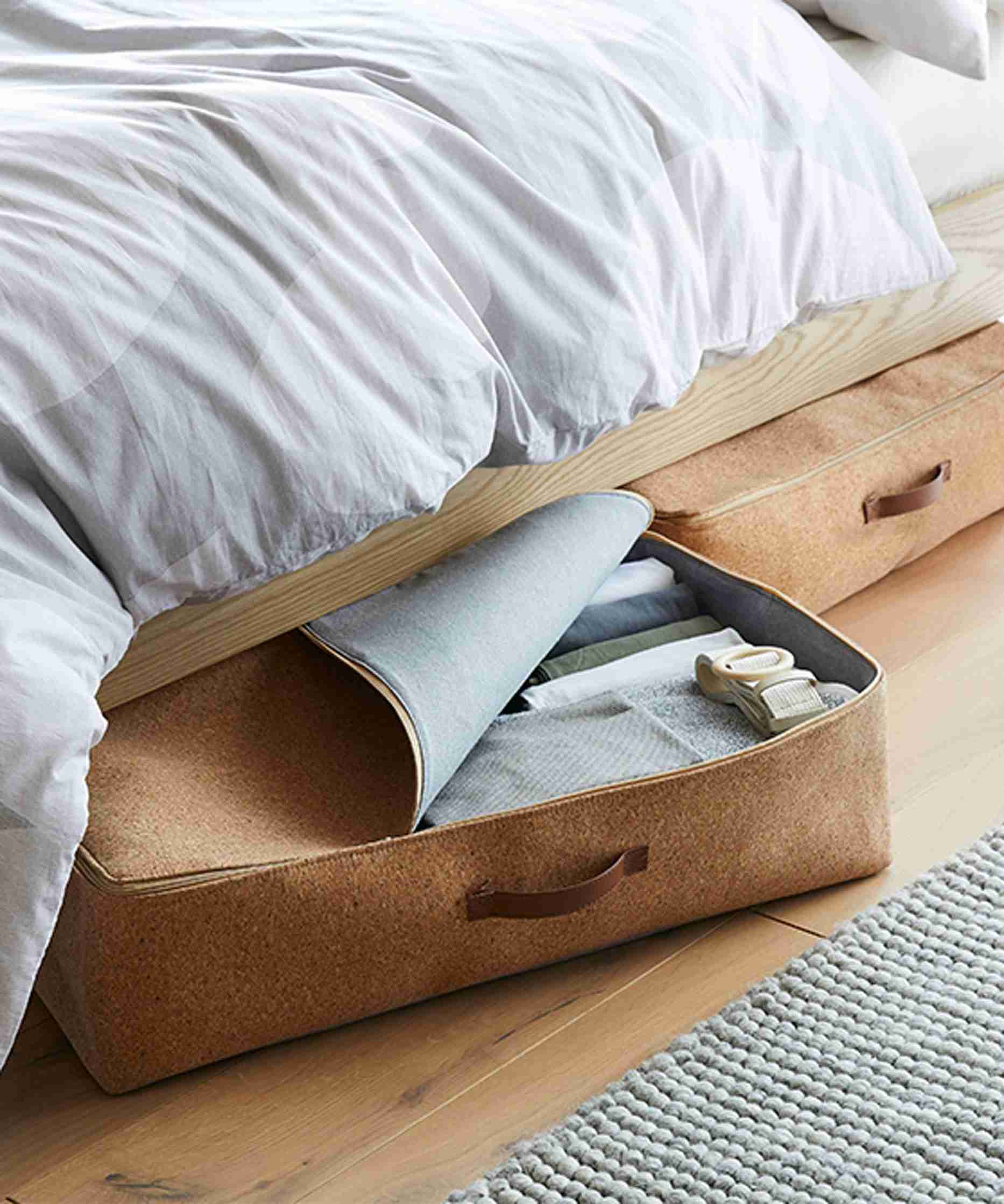The reference shows an open under-bed storage case with folded contents, illustrating a category that remains accessible rather than simply hidden.