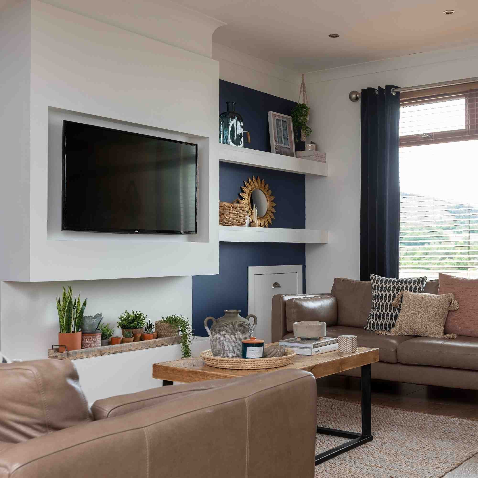 A source room arranges opposing sofas around a central table, with the screen on a side wall.