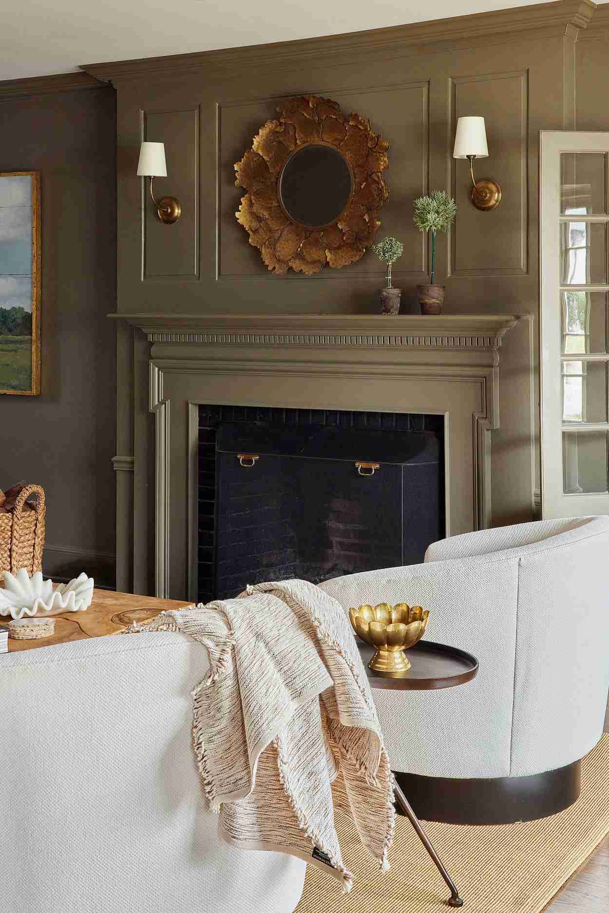The reference's olive-toned room pairs deeper painted surfaces with paler seating and warm accents, offering a different supporting palette from the cover.
